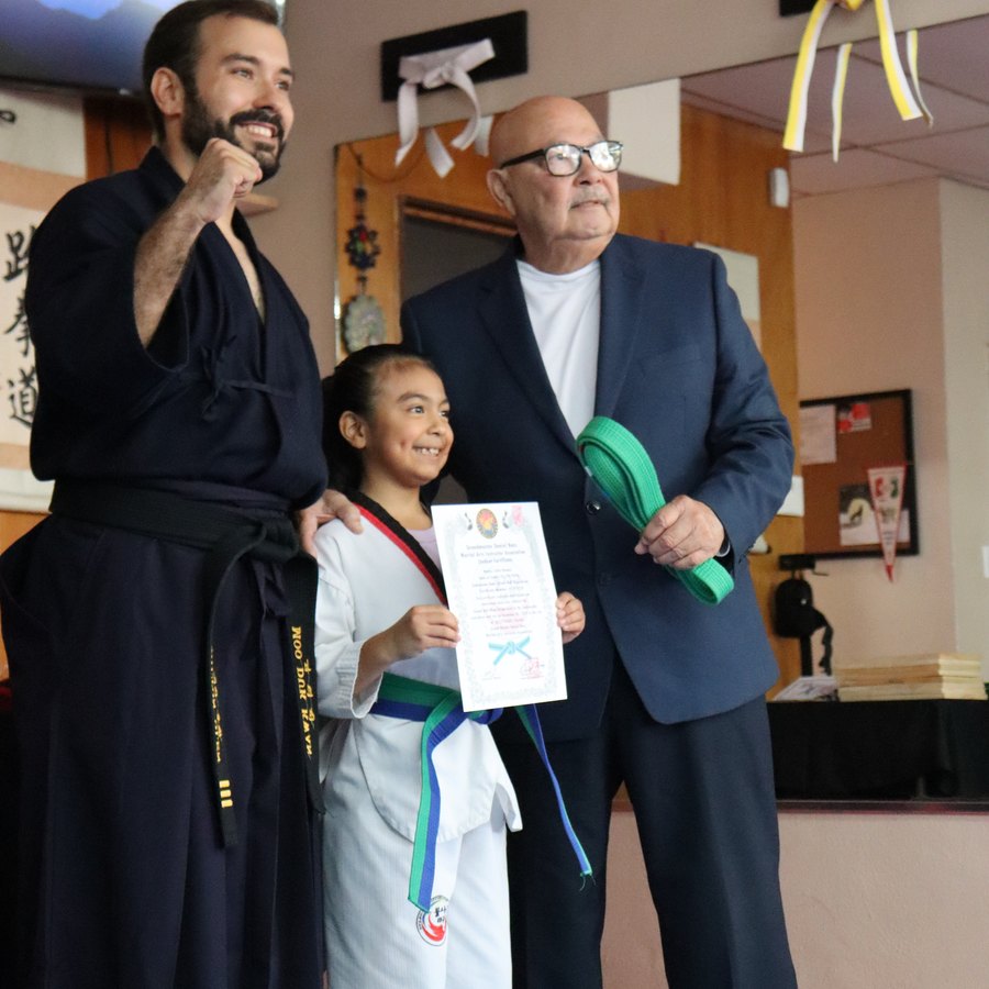 Student receiving a certificate with the instructor